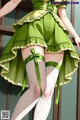 A woman in a green dress and white stockings.