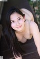 A young woman with long black hair posing for a picture.