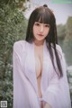 A woman in a white robe posing for a picture.
